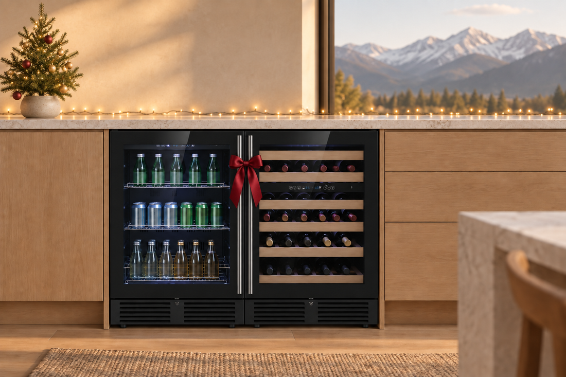 Elegant undercounter wine and beverage center decorated with a red ribbon, Christmas lights, and a miniature tree in a modern mountain-view kitchen.