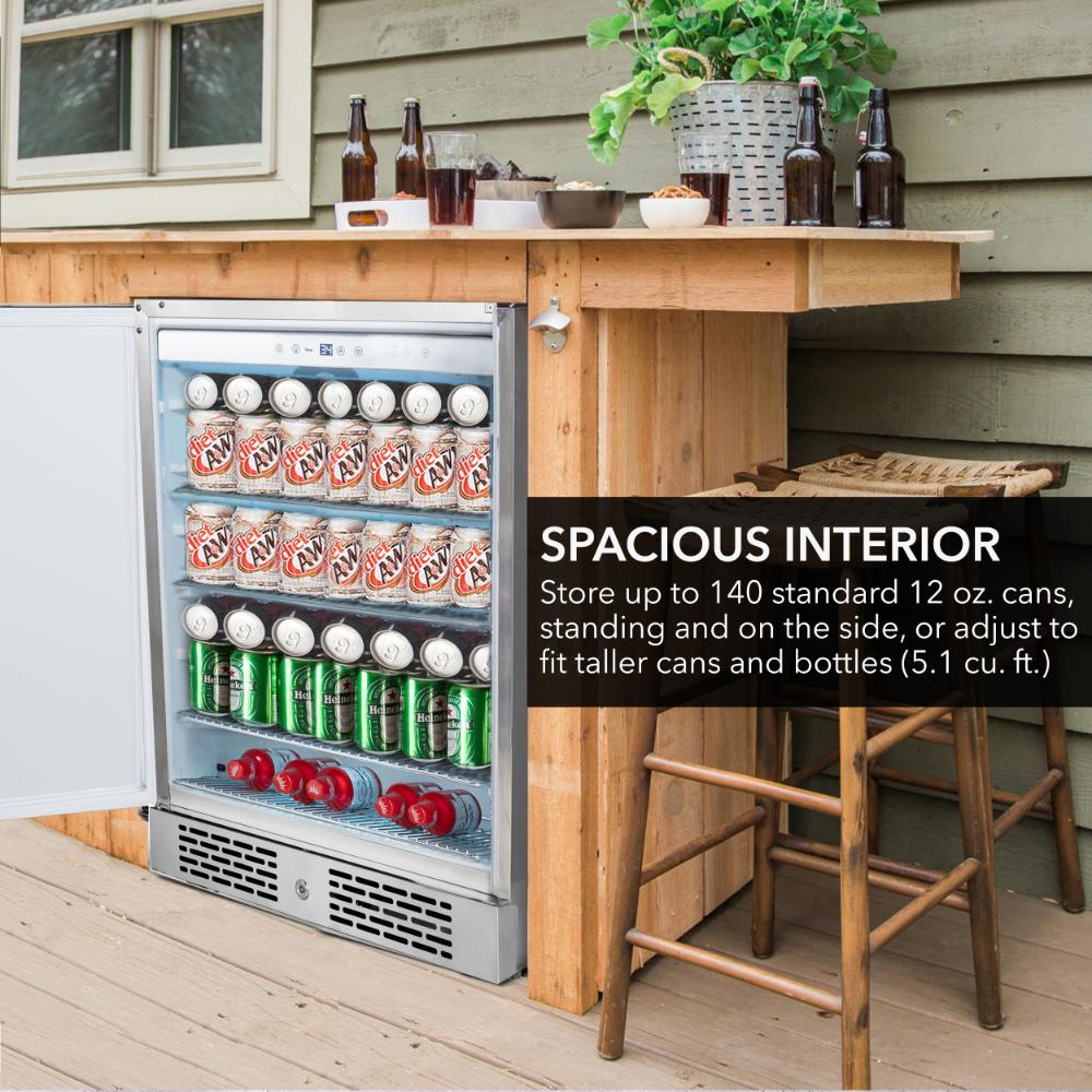 Outdoor setting with a refrigerator stocked with drinks, wooden table, and stools.