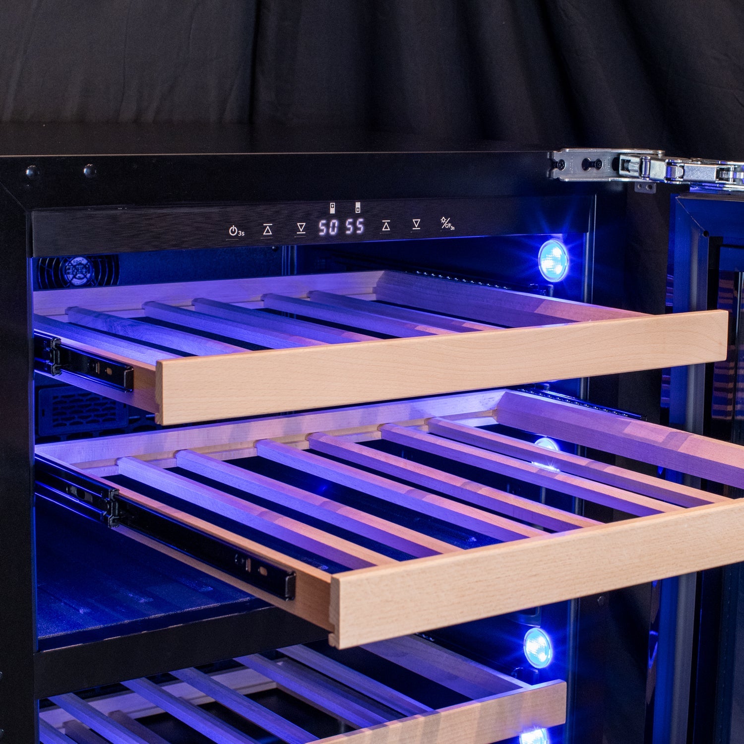 Close-up view of Allavino wine fridge’s metal front, glide-out shelves storing a variety of wine bottles and Blue LED lighting