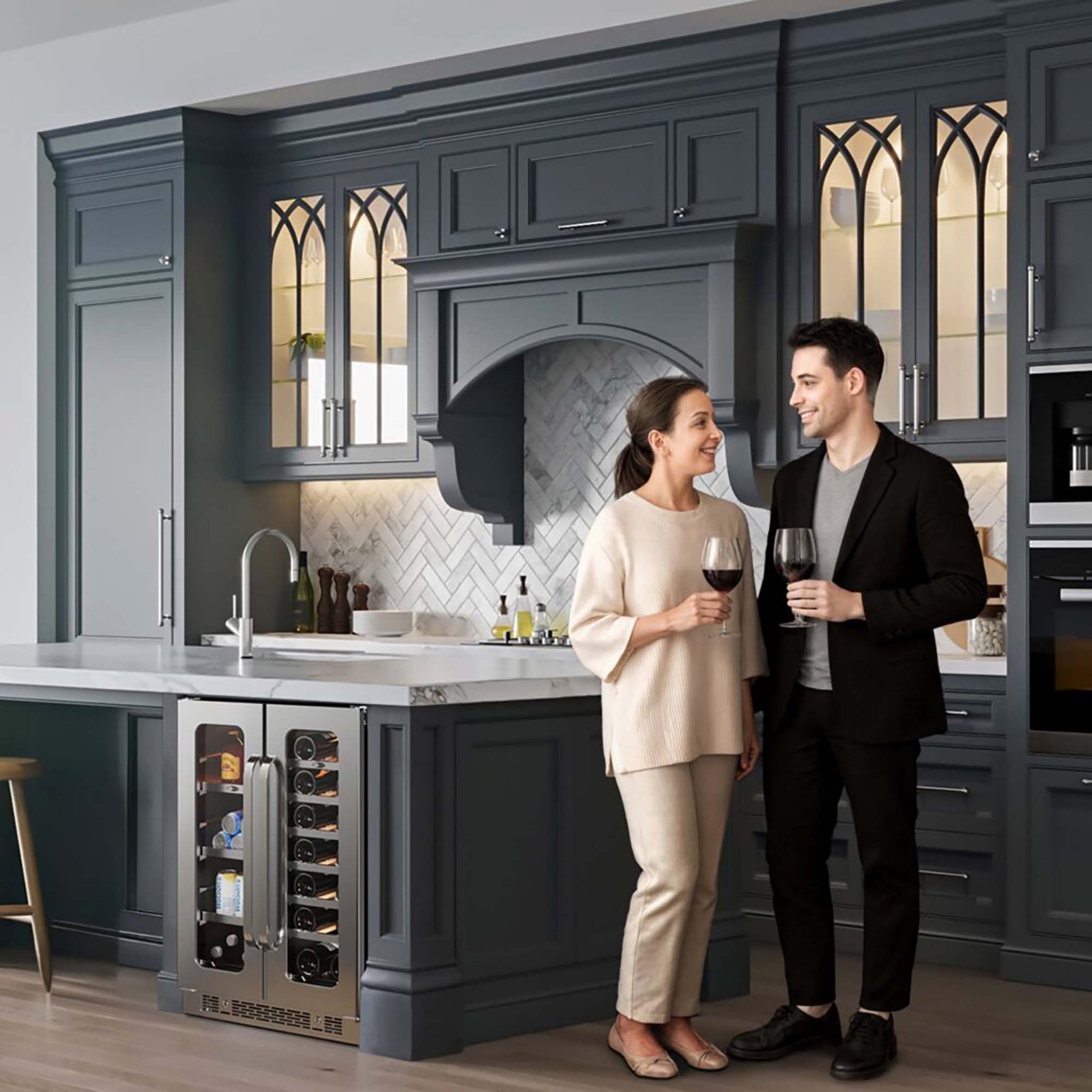 Couple beside a Whynter wine and beverage center installed in a gray kitchen island