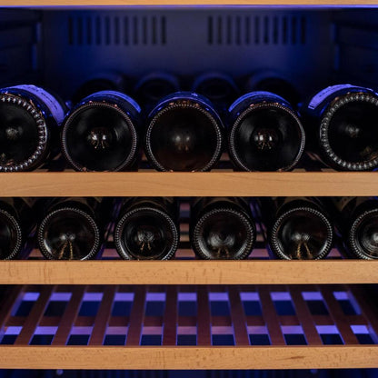 Wine bottles in a wooden wine rack with purple lighting. Larger bottle shown on top rack with bordeaux bottle on bottom