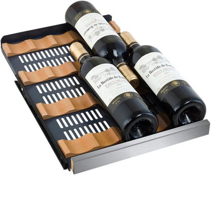 Three bottles of wine in a wooden wine rack on a white background