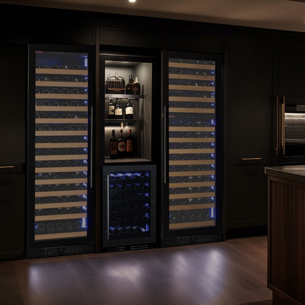 Stylish home bar featuring the Reserva 67-bottle wine refrigerator with dual zones and LED lighting